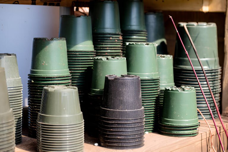 stacks of leftover plastic pots in a greenhouse